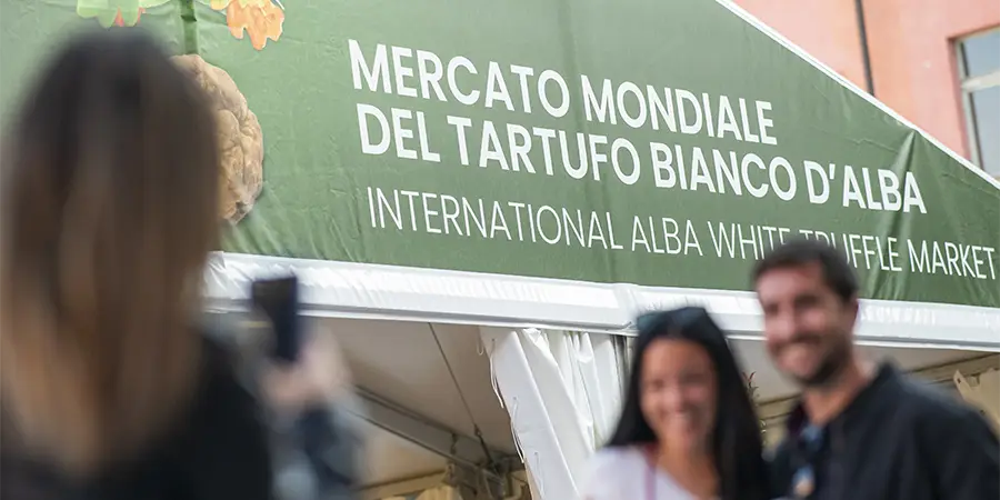 A couple in front of Tartufo Bianco d'Alba Market